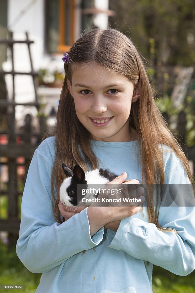 Girl, 10 years old, with pet rabbit