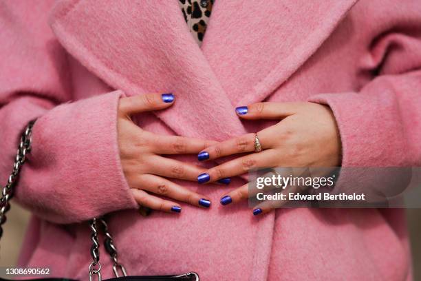 Geraldine Zerbib wears a pink oversized spring wool long coat from Essentiel Antwerp, blue nail polish, bejeweled finger rings, on March 17, 2021 in...