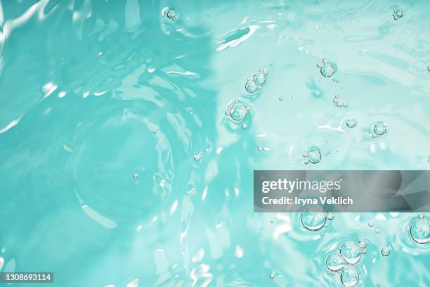 abstract background with moisturizing cleansing cosmetic gel, pure water or face serum, essential oil with oxygen aqua bubbles and waves. - mint green photos et images de collection