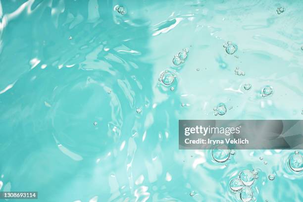 abstract background with moisturizing cleansing cosmetic gel, pure water or face serum, essential oil with oxygen aqua bubbles and waves. - ミントグリーン ストックフォトと画像