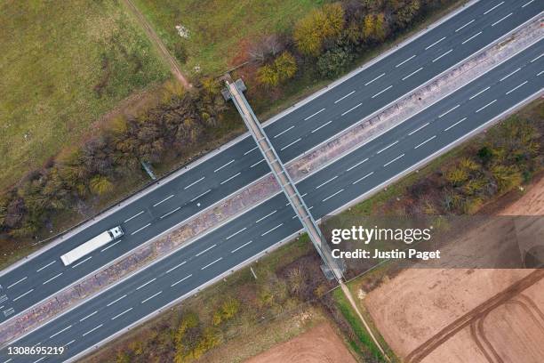 drone point of view of an articulated lorry on a major road - motorway uk stock pictures, royalty-free photos & images