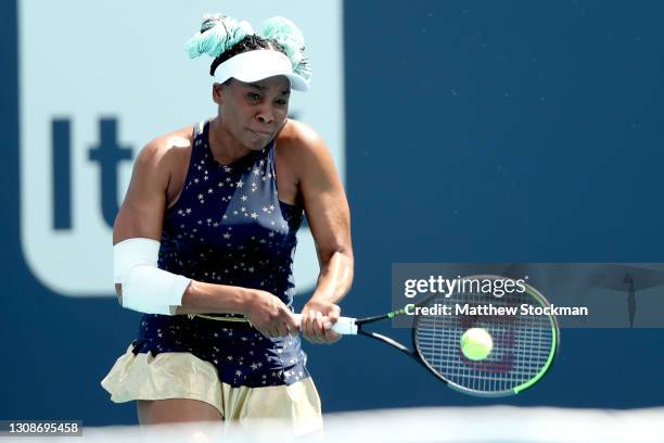 Venus Williams returns a shot to Zarina Diyas of Kazakhstan during the Miami Open at Hard Rock Stadium on March 23, 2021 in Miami Gardens, Florida.