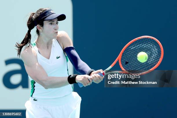 Christina McHale returns a shot to Laura Siegemund of Germany during the Miami Open at Hard Rock Stadium on March 23, 2021 in Miami Gardens, Florida.