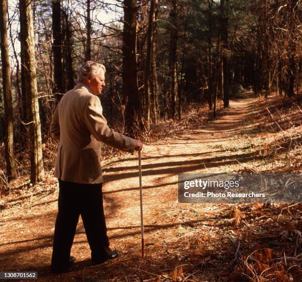 View of American Bluegrass musician Doc Watson as he walks along a trail near the Blue Ridge Parkway, North Carolina, 1990.