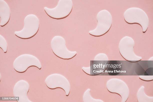 set of eye patches on pink background. trendy products of the year. health and wellness concept - eye patch stock pictures, royalty-free photos & images