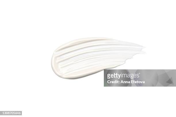 textured cosmetic smear of white cream isolated on white background. concept of health and wellbeing. flat lay style with copy space - creme stock-fotos und bilder