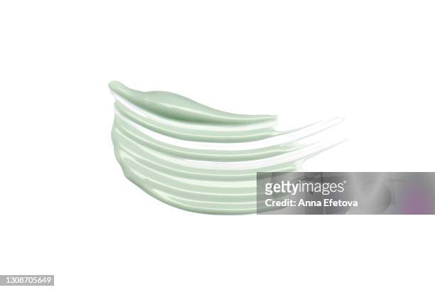 textured cosmetic smear of pastel green cream isolated on white background. concept of health and wellbeing. flat lay style with copy space - green room stockfoto's en -beelden