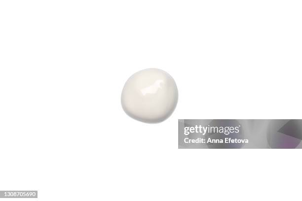 cosmetic drop of white cream isolated on white background. concept of health and wellbeing. flat lay style with copy space - room plant stockfoto's en -beelden