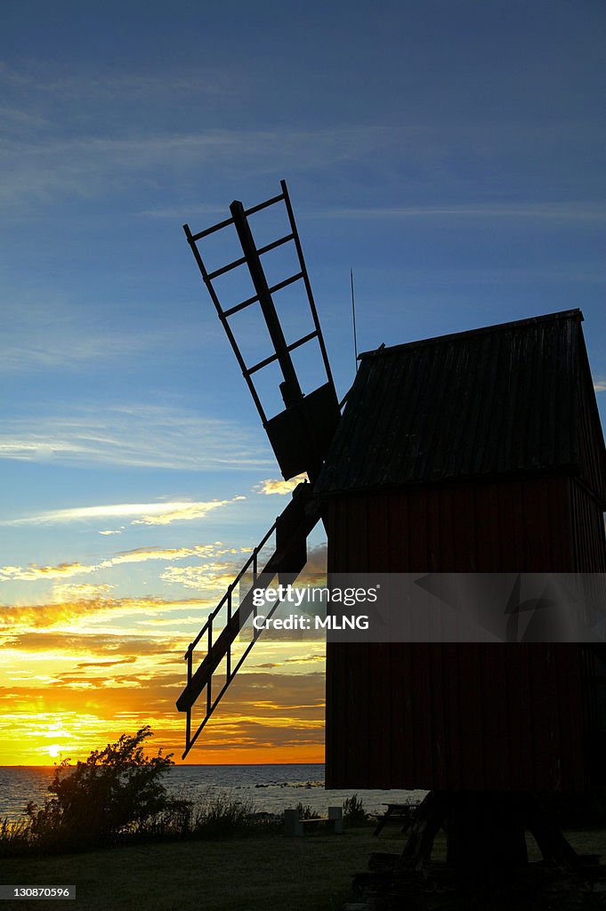 Sweden, Island Oland, windmill and sunset