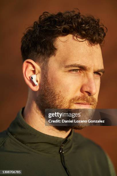 close up of a wireless headphone holding itself on a man's ear - face high contrast stock pictures, royalty-free photos & images