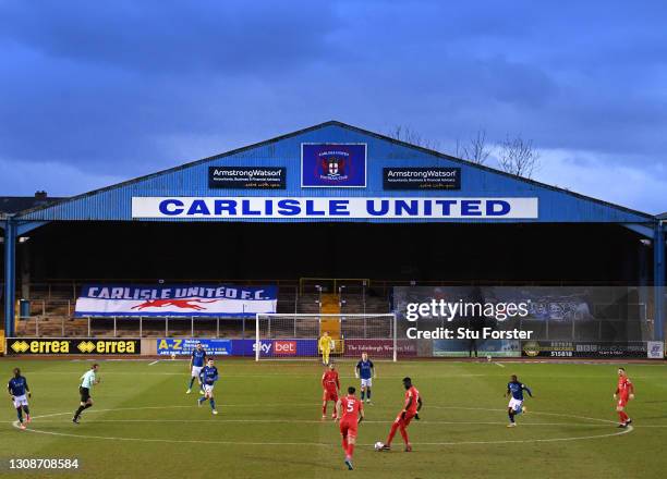 General view of the action at Brunton Park as the empty stands display banners during the Sky Bet League Two match between Carlisle United and Leyton...