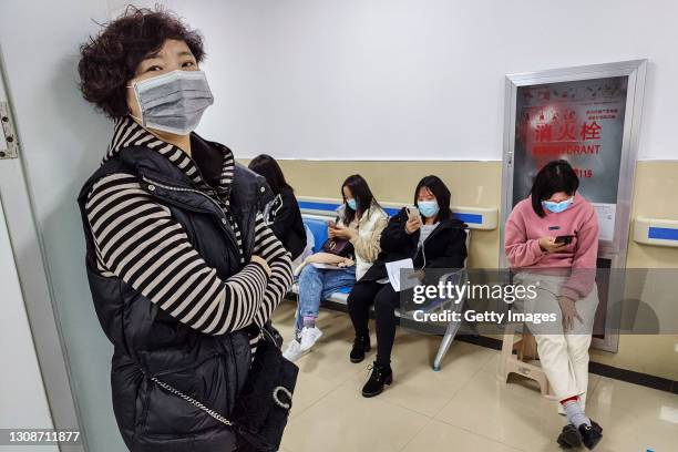 Residents who received the COVID-19 vaccination are seen resting at the Community hospital on March 23, 2021 in Wuhan, Hubei Province, China....