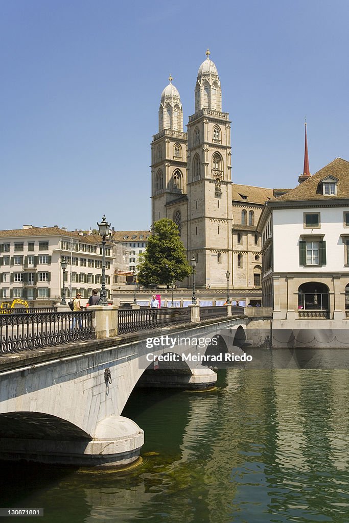 At the Limmat with the Grossmuenster Cathedral, Zurich, Switzerland