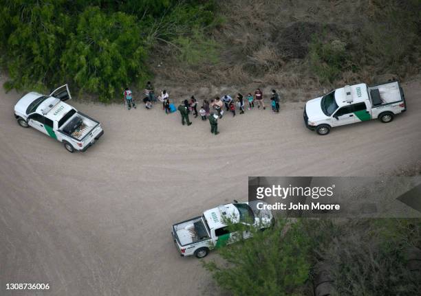 Border Patrol agents take asylum seekers into custody as seen from a Texas Department of Public Safety helicopter near the U.S.-Mexico Border on...
