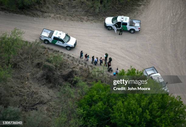 Border Patrol agents take asylum seekers into custody as seen from a Texas Department of Public Safety helicopter near the U.S.-Mexico Border on...