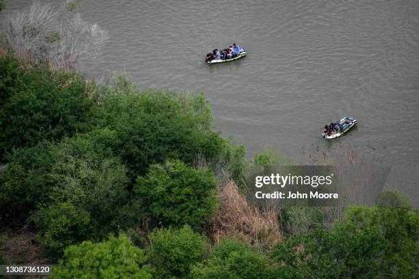 Smugglers ferry asylum seekers across the Rio Grande in dinghies as seen from a Texas Department of Public Safety helicopter near the U.S.-Mexico...