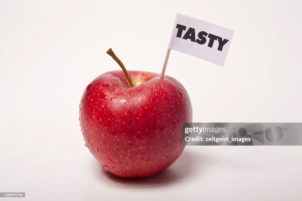 Red apple, flag saying tasty