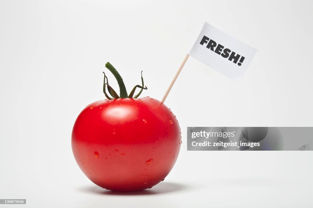 Red tomato, flag saying fresh!