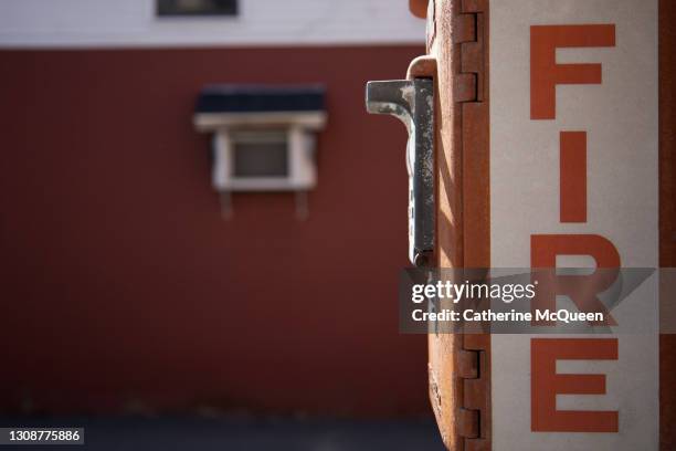 outdoor emergency fire department box at building entrance - vintage fire extinguisher stock pictures, royalty-free photos & images