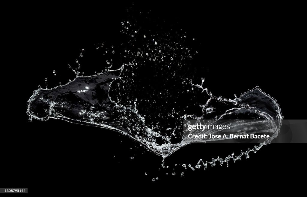 Shock of liquids (water) that produce splashes and drops on a black background.