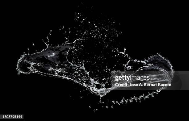 shock of liquids (water) that produce splashes and drops on a black background. - splash fotografías e imágenes de stock