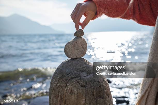 Man Stacking Rocks Stacking Stones On Beach Photos and Premium High Res Pictures - Getty ...