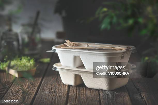 delivered food in eco friendly paper packaging boxes on wooden table . - fast food stock pictures, royalty-free photos & images