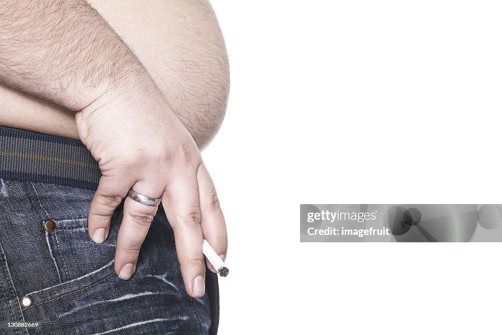 Man holding cigarette between two fingers, presenting his beer belly