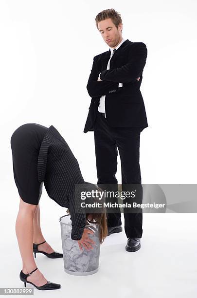 businesswoman watching businesswoman sticking her head in a bin - man standing full body isolated stock pictures, royalty-free photos & images