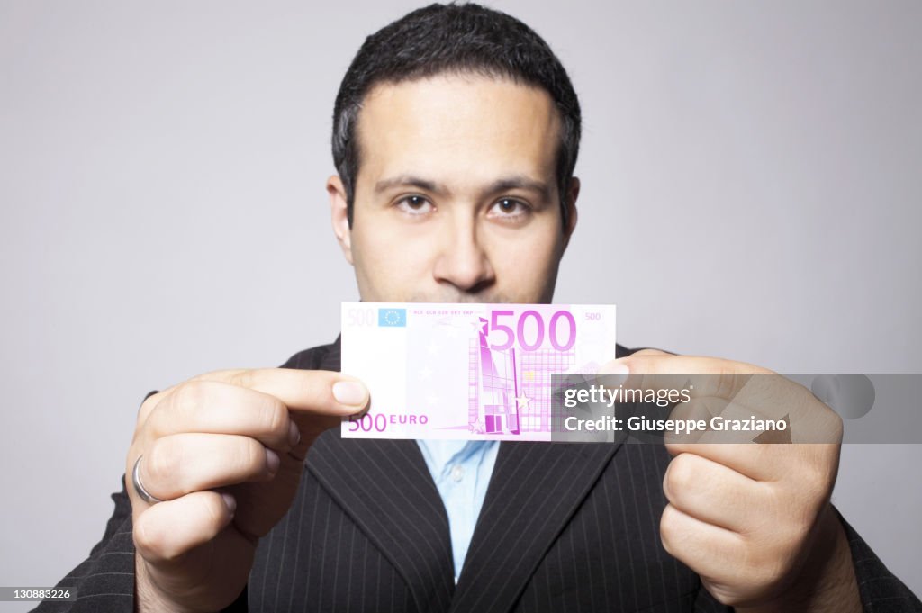 Man Offers A 500 Euro Banknote High Res Stock Photo Getty Images man-offers-a-500-euro-banknote-high-res-stock-photo-getty-images