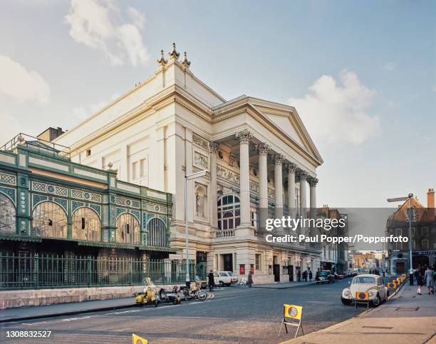 View of the front entrance to the Royal Opera House, with the Floral Hall on left, on Bow Street in Covent Garden, London circa 1975. This, the third...