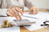 Business woman using calculator to manage finance