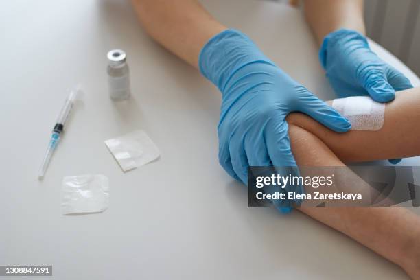 doctor applies a patch after the vaccination. treatment of the injection. close-up. vaccination. the injection. - meningitis stock pictures, royalty-free photos & images