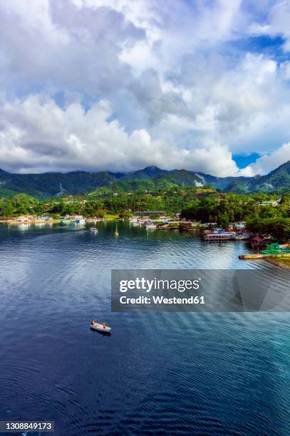 papuanew guinea, milne bay province, alotau, aerial view of clouds over coastal town - alotau papua new guinea stock pictures, royalty-free photos & images