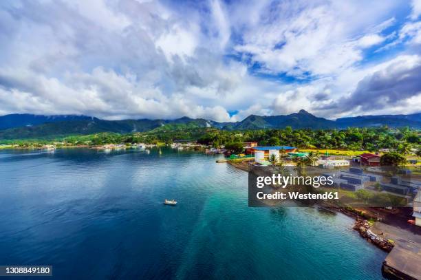 papua new guinea, milne bay province, alotau, aerial view of clouds over coastal town - alotau papua new guinea stock pictures, royalty-free photos & images