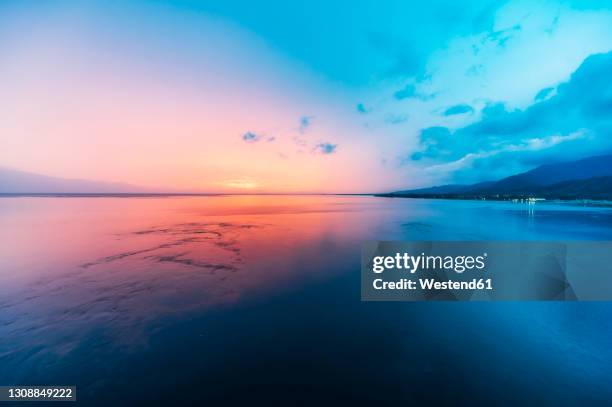 papua new guinea, milne bay province, alotau, long exposure of sea at dusk - alotau papua new guinea stock pictures, royalty-free photos & images