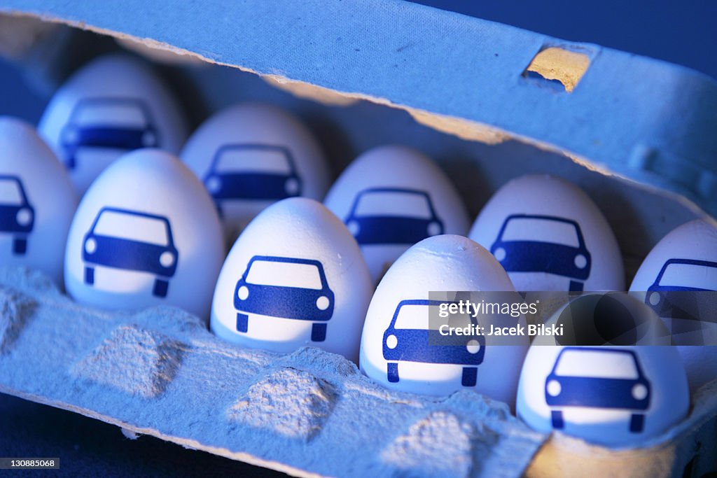 Eggs with pictures of car in an egg carton