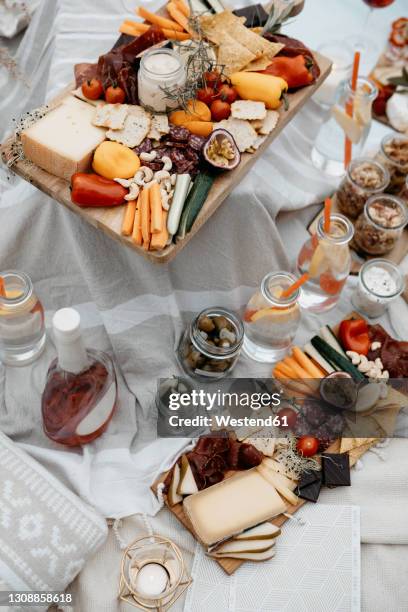 abundance of food for a picnic on white blanket - food abundance stock pictures, royalty-free photos & images