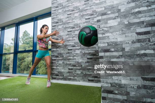 sportswoman exercising with medicine ball in gym - medicine ball stock pictures, royalty-free photos & images