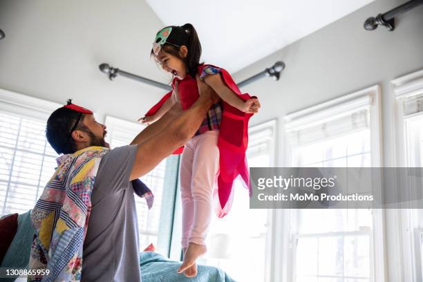 father and daughter playing in homemade costumes - chinese family with one child stock pictures, royalty-free photos & images