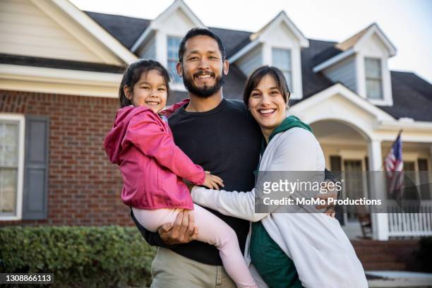 portrait of family in front of suburban home - chinese family taking photo at home stock-fotos und bilder