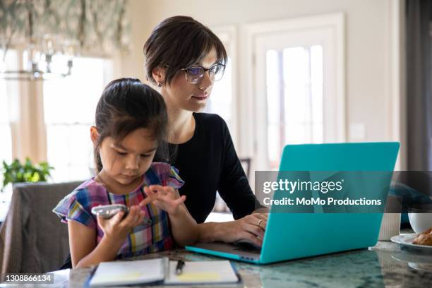 mother working from home and playing with young daughter - leanincollection working mom fotografías e imágenes de stock