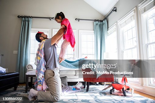 Father and daughter playing in homemade costumes Father and daughter playing in homemade costumes