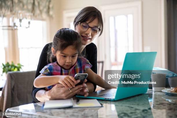 mother working from home and playing with young daughter - kid using phone stock pictures, royalty-free photos & images