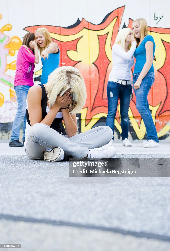 Teenage girl being bullied by peers