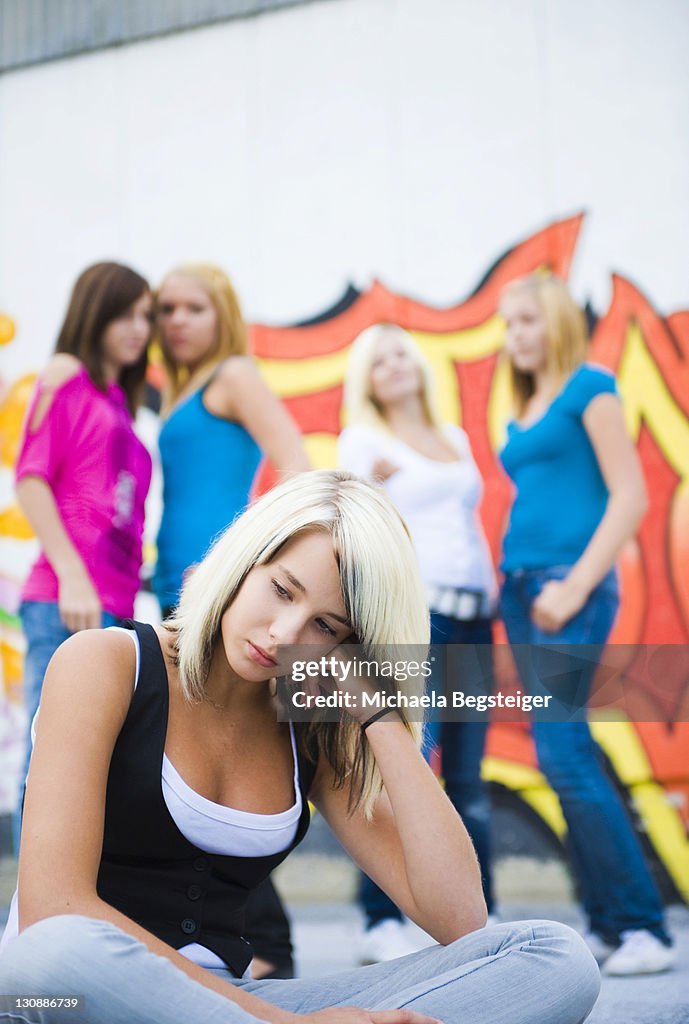 Teenage girl being bullied by peers