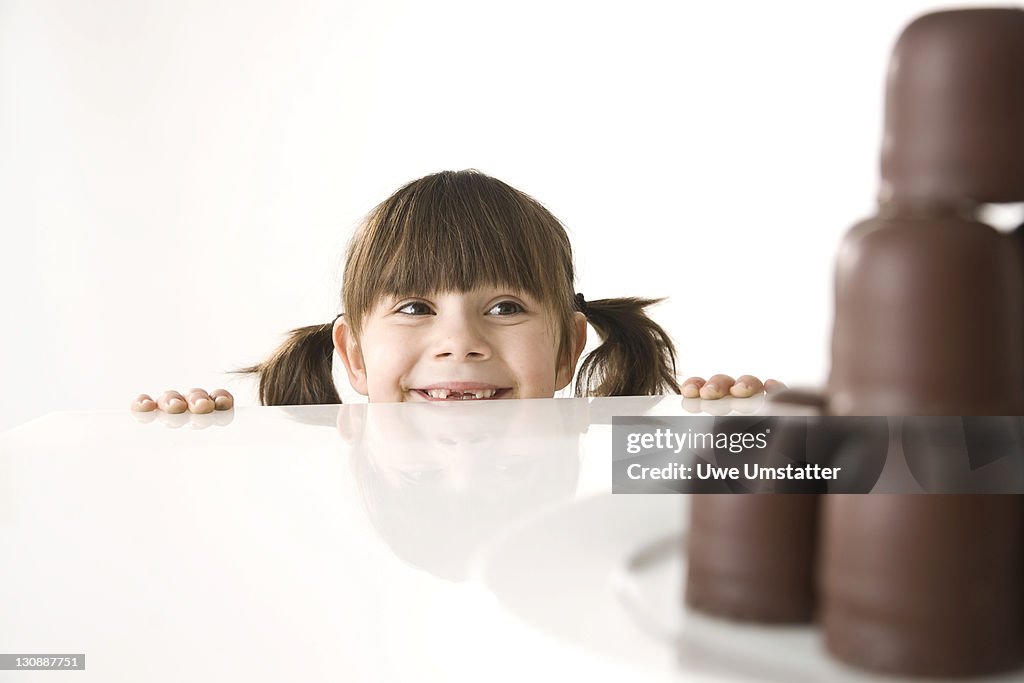 Girl in front of a plate of chocolate marshmallows