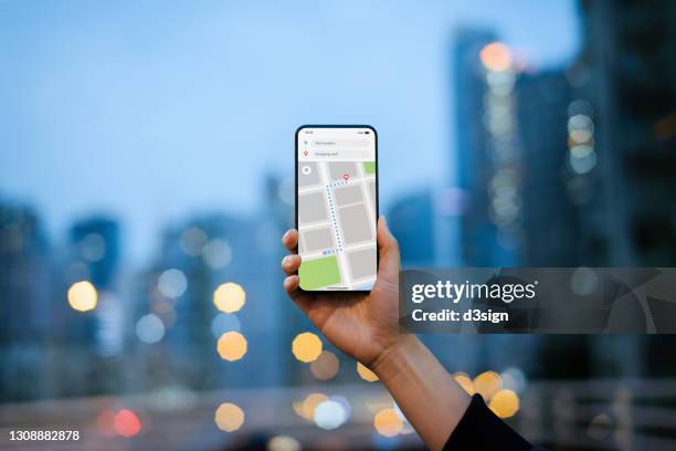 cropped shot of woman's hand using map in mobile app device on smartphone to navigate and search for location in the city. travel and navigation concept - tourist map stock pictures, royalty-free photos & images