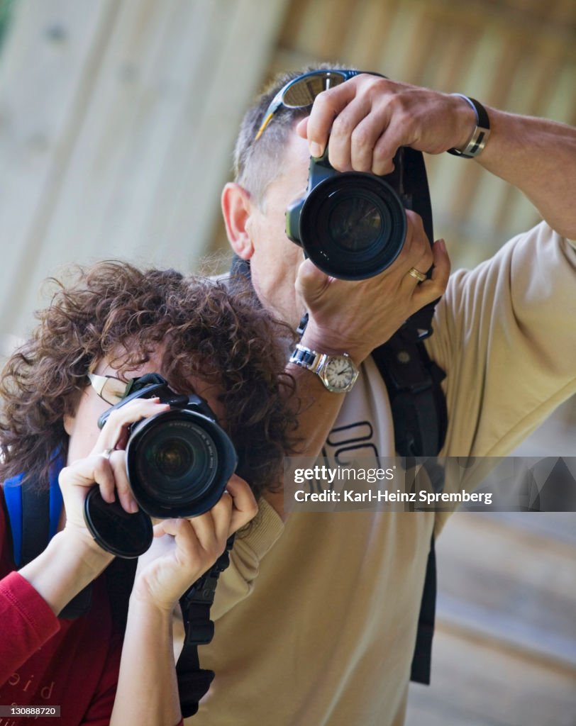 Two people with photo cameras