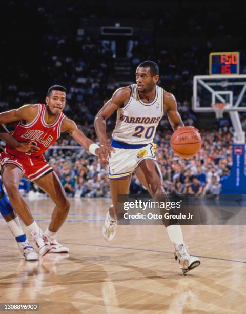 Terry Teagle, Shooting Guard and Small Forward for the Golden State Warriors dribbles the basketball around Brad Sellers of the Chicago Bulls during...